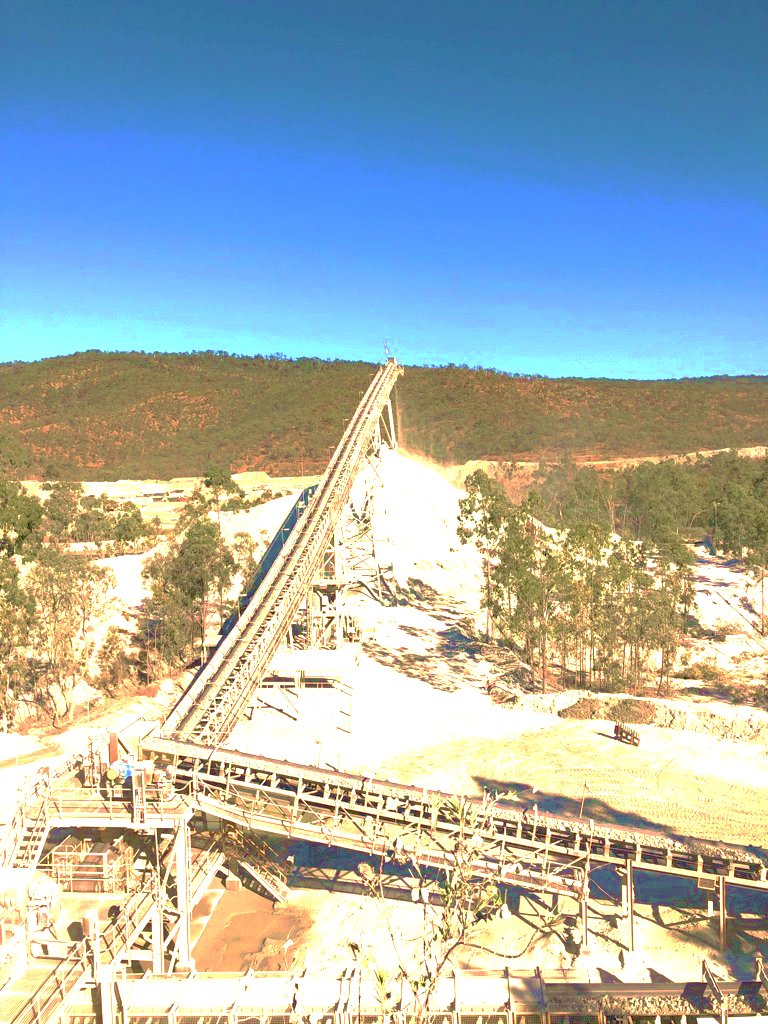 A conveyor running up from a processing plant at a mine site